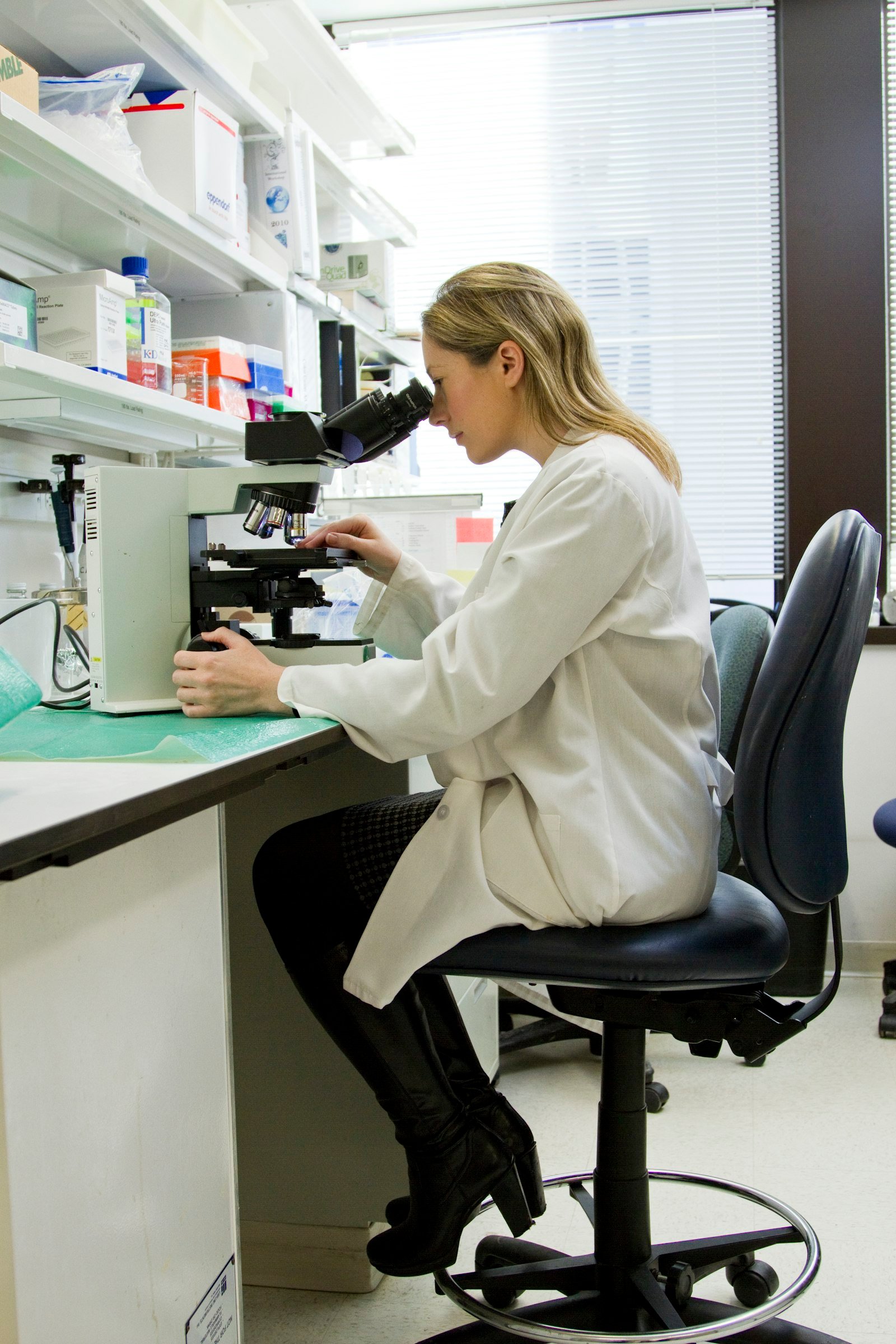 Cosmetic formulation chemist working with pipettes and samples in a clean laboratory